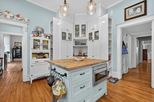 a kitchen with stainless steel appliances granite countertop a stove refrigerator and cabinets