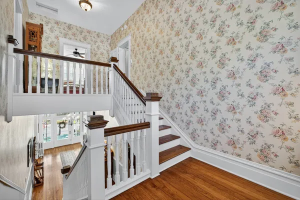 a bedroom with bed and a chandelier