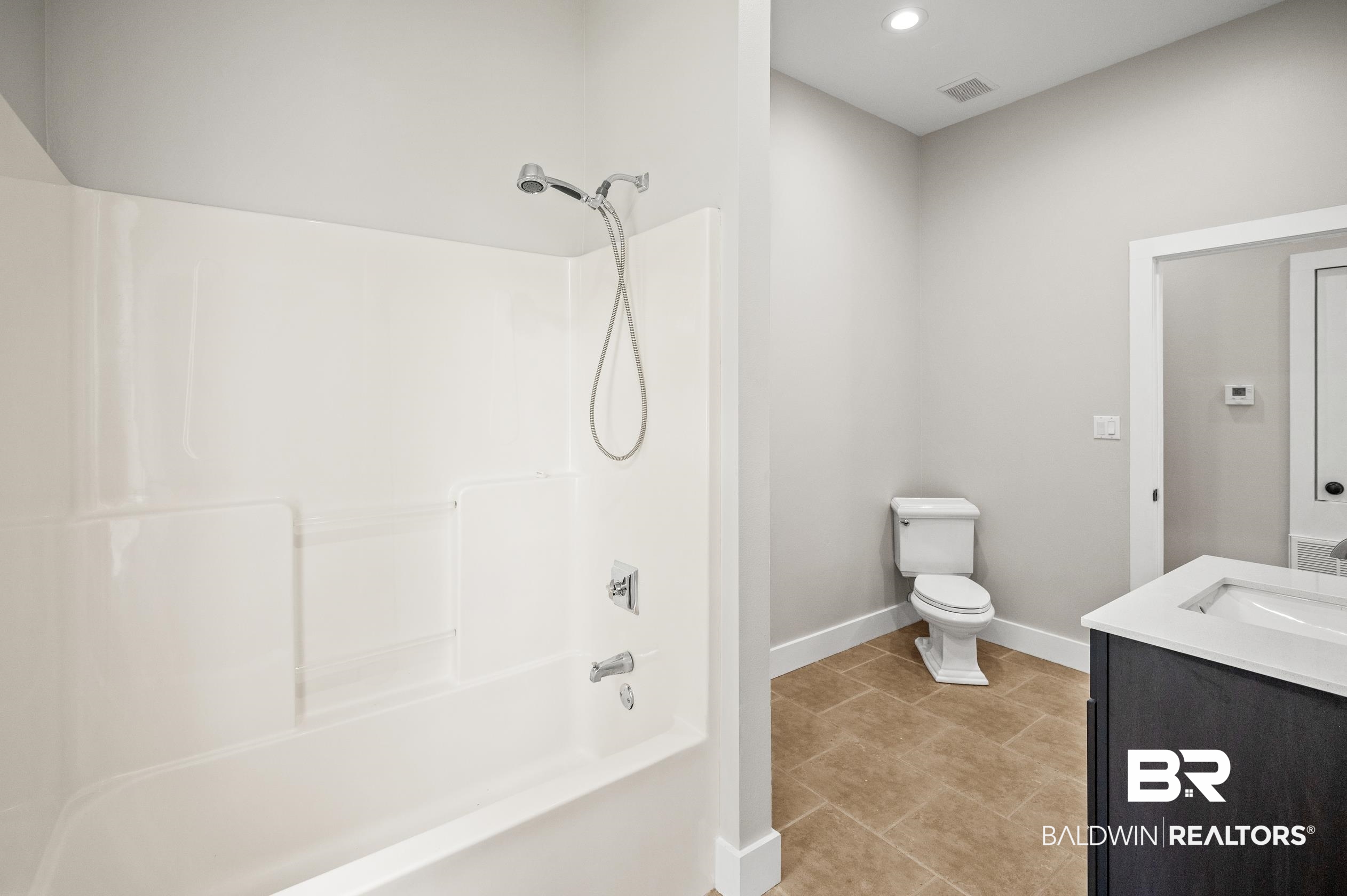 15031 Timber Ridge Drive Loxley, AL 36551 - Photo 35 of 43 Full bathroom featuring tile patterned floors, vanity, shower / washtub combination, and toilet
