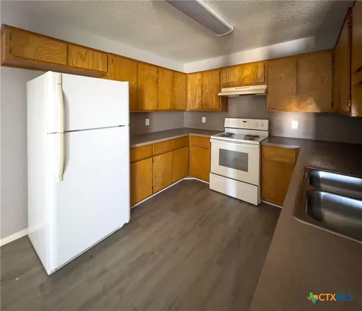 a kitchen with a refrigerator and a stove