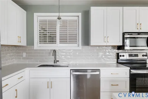 a kitchen with appliances cabinets and a sink