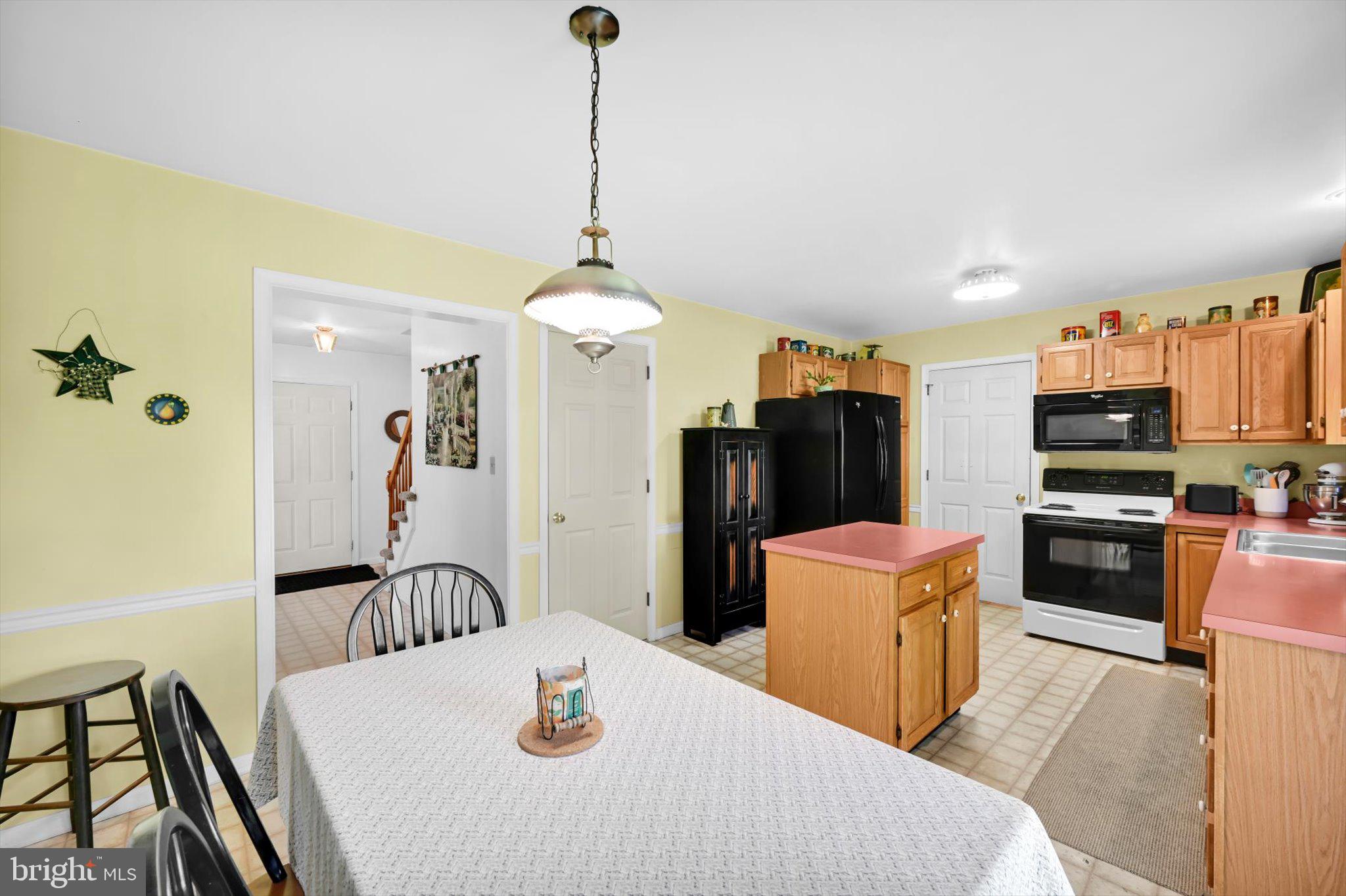 30 Edgewood Drive Lititz, PA 17543 - Photo 11 of 47 a kitchen with stainless steel appliances kitchen island granite countertop a refrigerator a stove top oven a sink dishwasher and a dining table with wooden floor