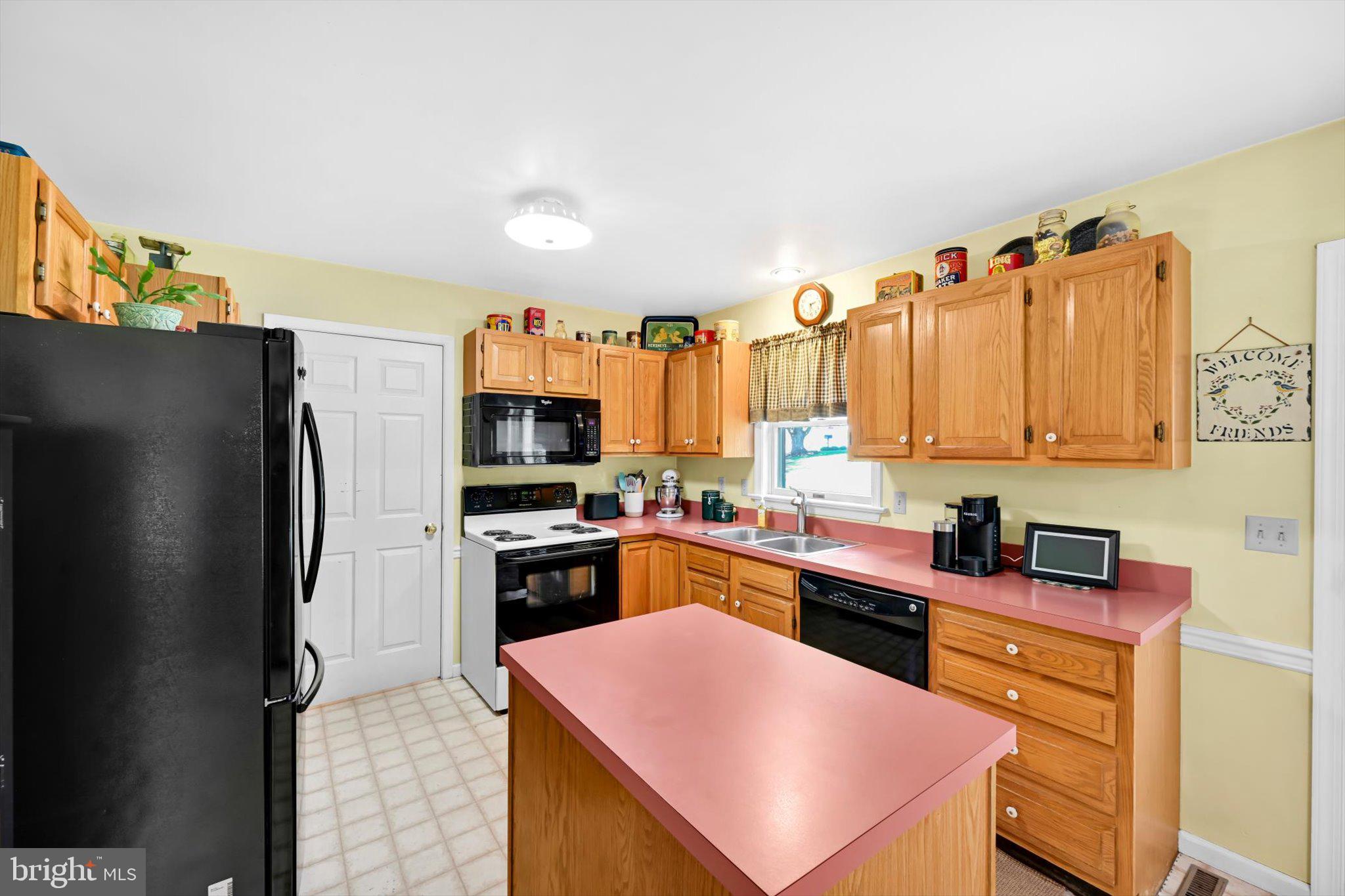 30 Edgewood Drive Lititz, PA 17543 - Photo 13 of 47 a kitchen with granite countertop stainless steel appliances a sink dishwasher a refrigerator a stove top oven and wooden floor