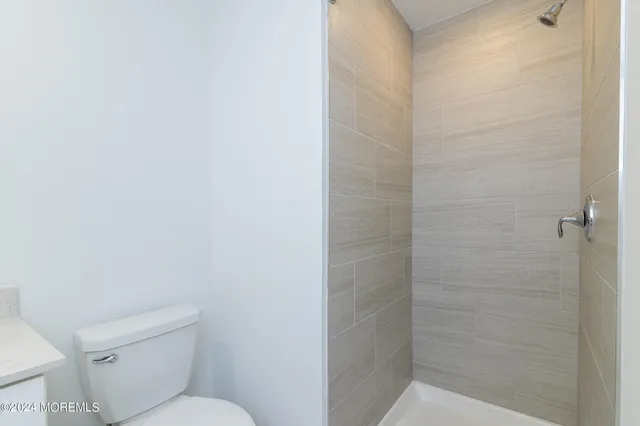 a bathroom with a toilet and a shower