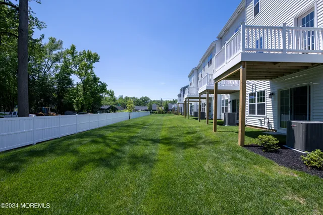 a view of a house next to a yard and deck