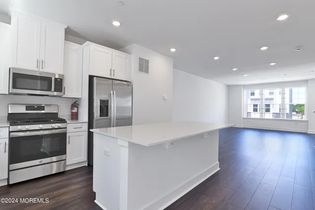 a kitchen with stainless steel appliances a stove a sink and a microwave