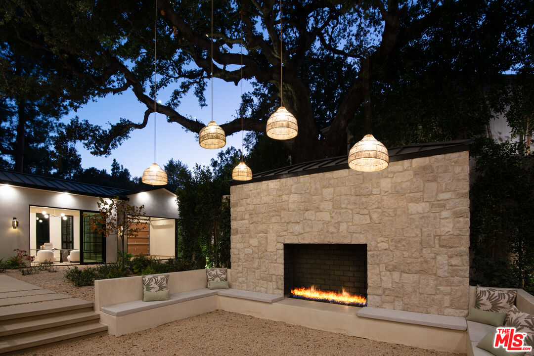 17321 Rancho Street Encino, CA 91316 - Photo 24 of 52 a front view of a house with a yard