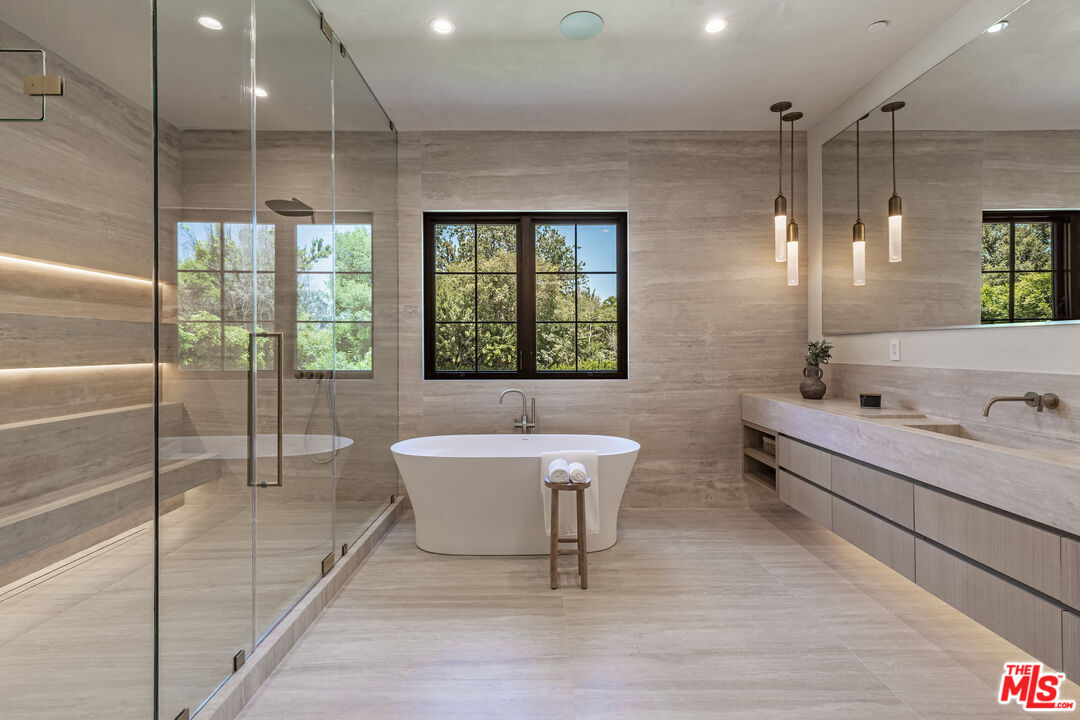 17321 Rancho Street Encino, CA 91316 - Photo 28 of 52 a bathroom with a sink and a large mirror