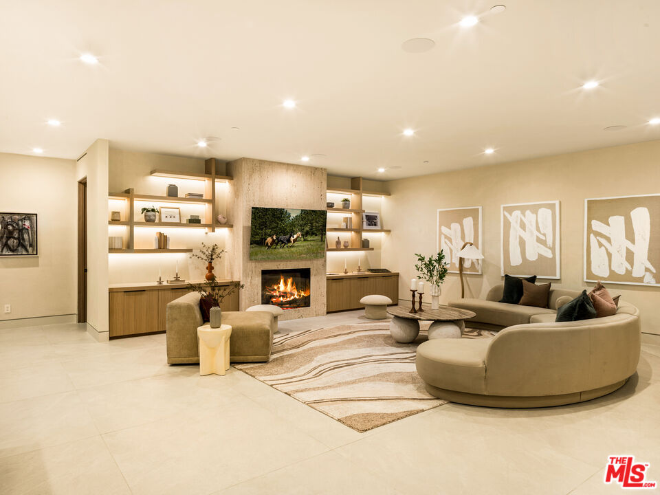 17321 Rancho Street Encino, CA 91316 - Photo 33 of 52 a living room with fireplace furniture and a flat screen tv