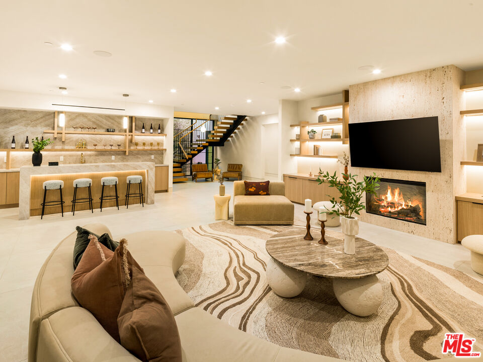 17321 Rancho Street Encino, CA 91316 - Photo 35 of 52 a living room with furniture and a flat screen tv
