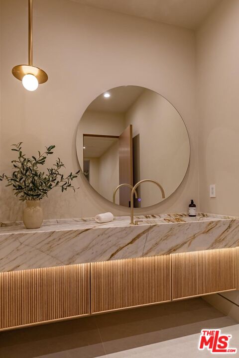 17321 Rancho Street Encino, CA 91316 - Photo 38 of 52 a bedroom with a bed and a chandelier