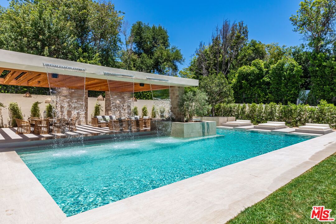 17321 Rancho Street Encino, CA 91316 - Photo 47 of 52 a view of a patio with table and chairs under an umbrella