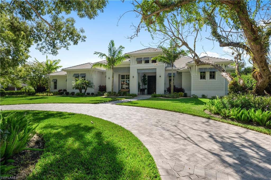 680 Yucca Road Naples, FL 34102 - Photo 1 of 31 a front view of house with yard and green space