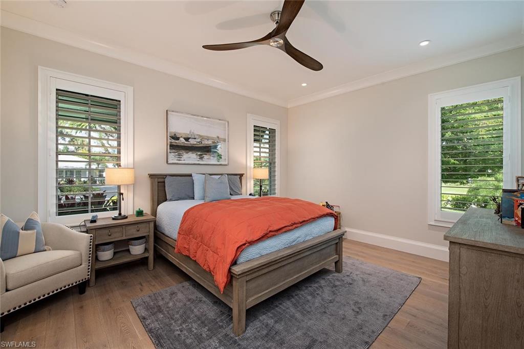 680 Yucca Road Naples, FL 34102 - Photo 21 of 31 a bed room with a bed and a couch