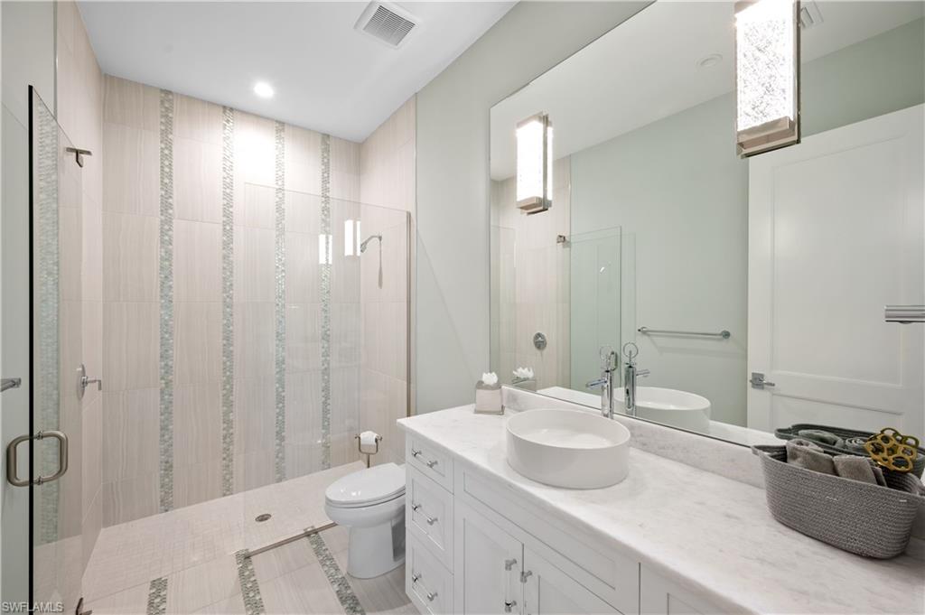 680 Yucca Road Naples, FL 34102 - Photo 24 of 31 a bathroom with a sink toilet and shower