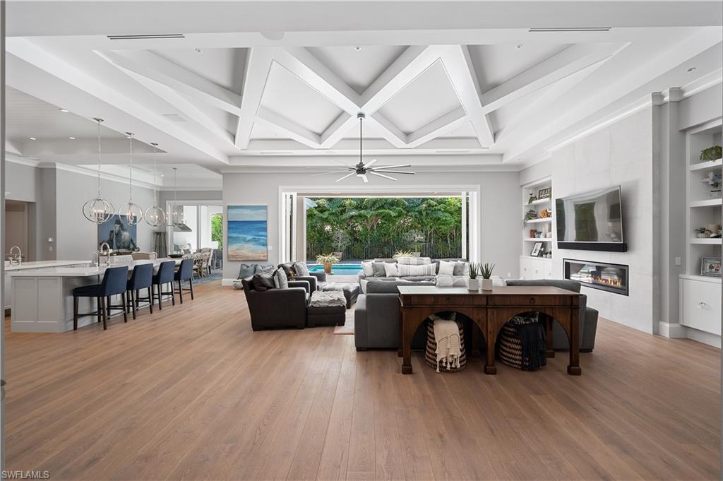 680 Yucca Road Naples, FL 34102 - Photo 3 of 31 a living room with furniture a wooden floor and a large window