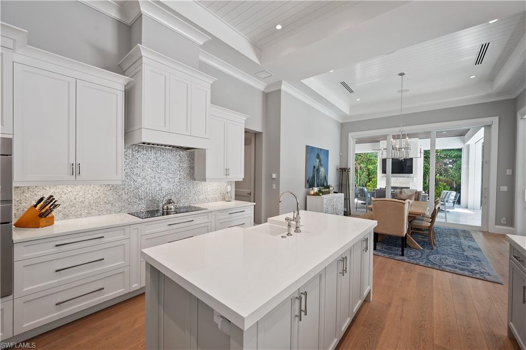 680 Yucca Road Naples, FL 34102 - Photo 9 of 31 a large white kitchen with a large window