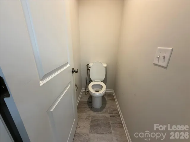 a white toilet sitting in a bathroom