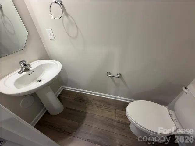 a bathroom with a sink mirror and toilet