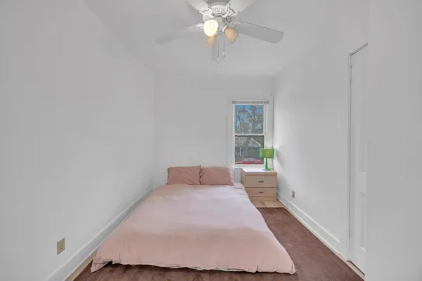 a bedroom with a bed and a window