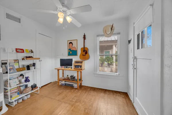a view of a workspace with furniture and a window