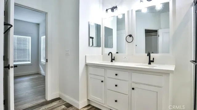 a bathroom with double vanity sinks and a mirror