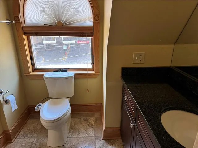 a bathroom with a sink shower and a mirror