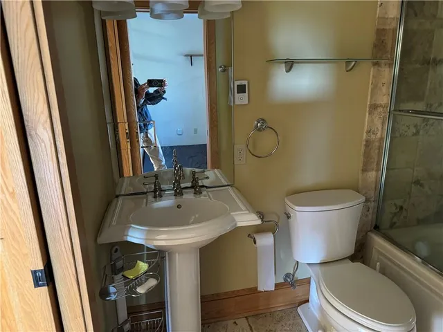 a bathroom with a sink toilet and shower