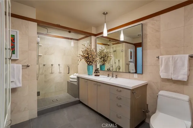 a bathroom with a sink vanity granite and shower