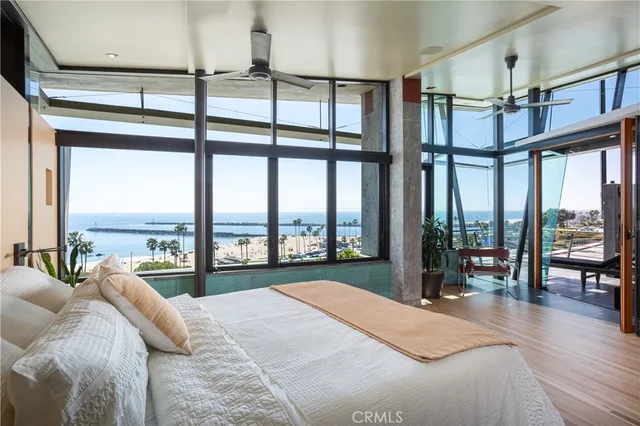 a bedroom with furniture and a large window