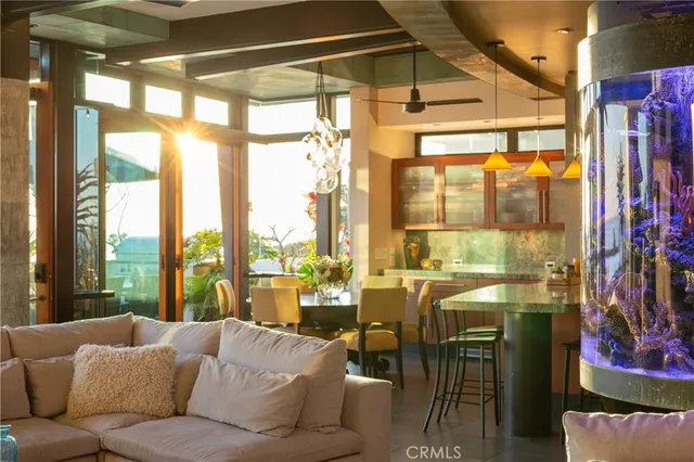 a living room with furniture and a floor to ceiling window