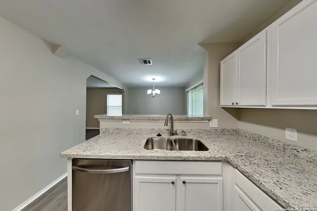 a kitchen with a sink and cabinets