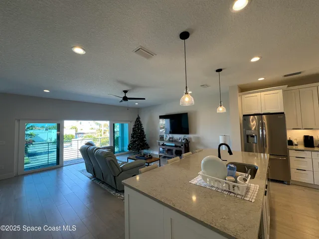 a living room with furniture wooden floor and a flat screen tv