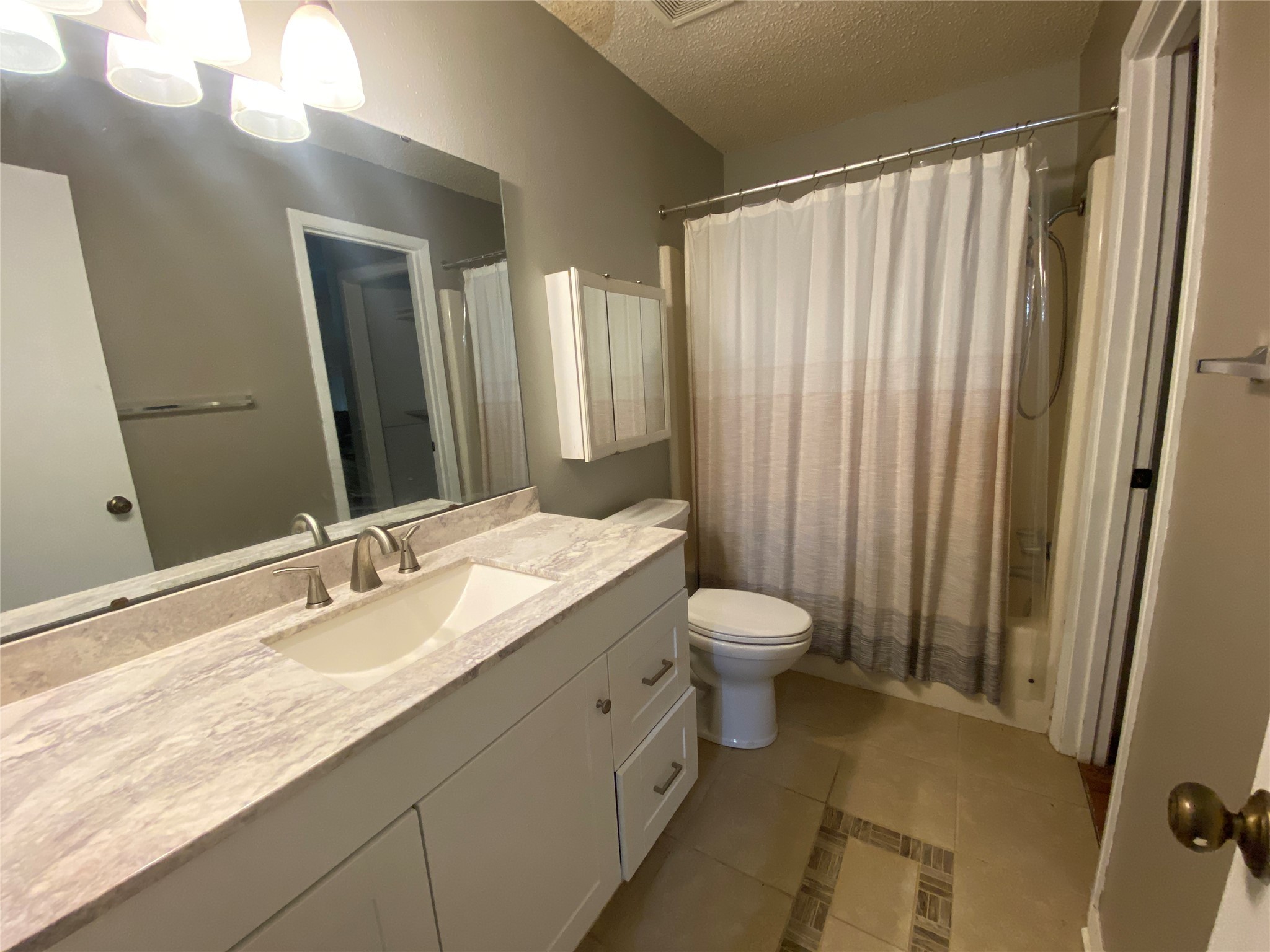 28604 Magnolia Court Point Blank, TX 77364 - Photo 13 of 30 a bathroom with a granite countertop sink toilet and shower