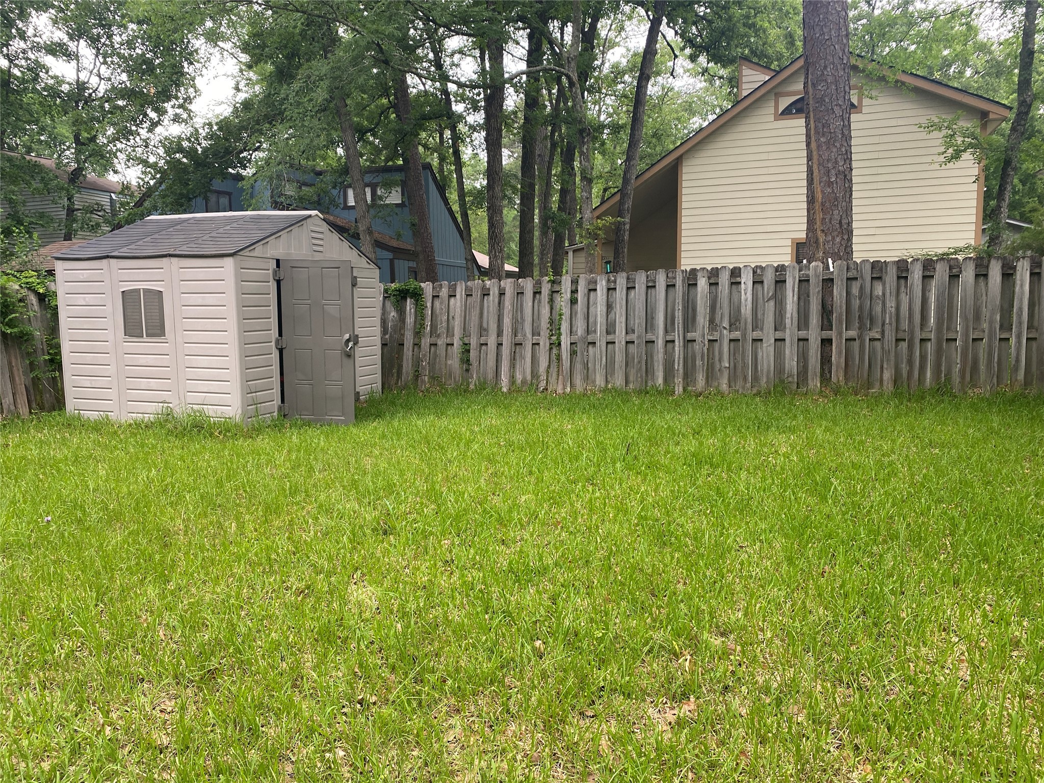 28604 Magnolia Court Point Blank, TX 77364 - Photo 17 of 30 a view of a house with a yard and wooden fence