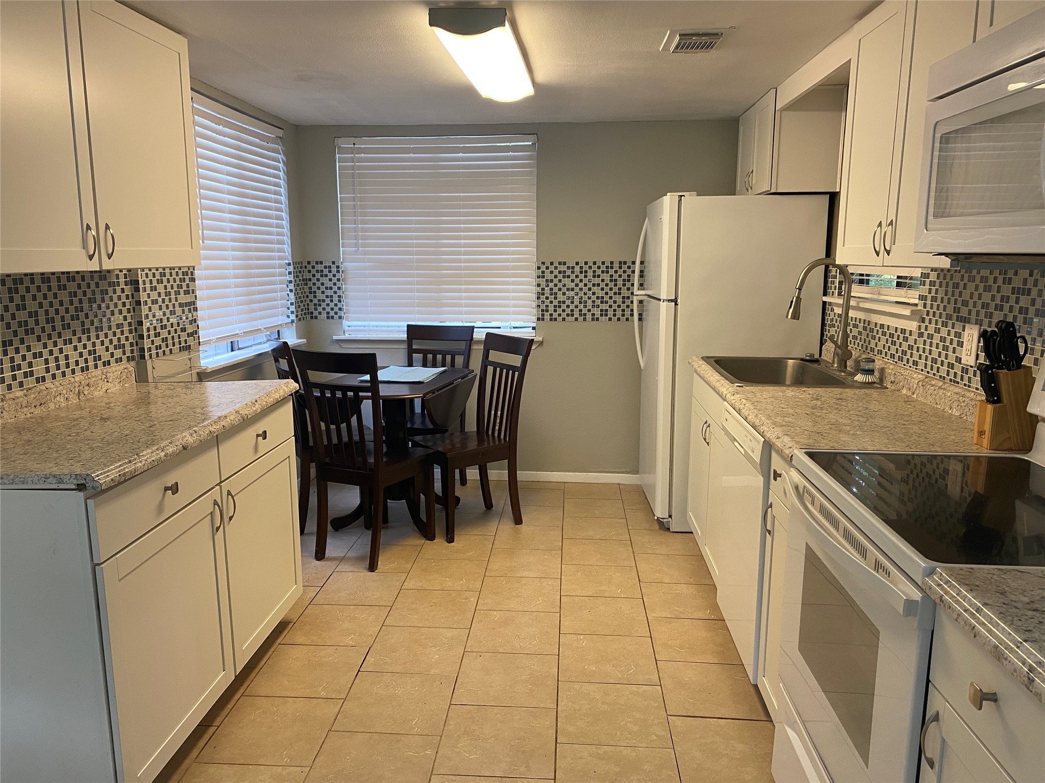 28604 Magnolia Court Point Blank, TX 77364 - Photo 19 of 30 a kitchen with a cabinets a sink a counter and appliances