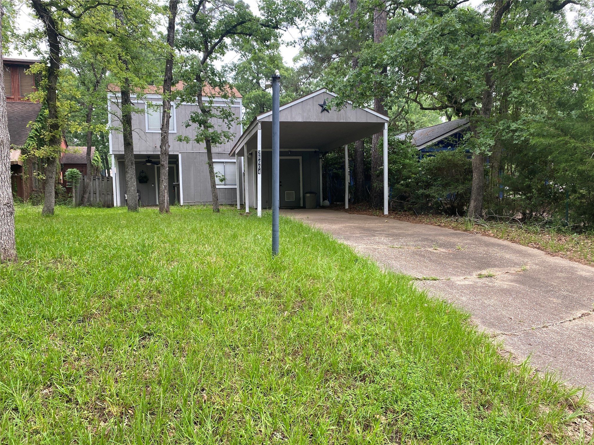 28604 Magnolia Court Point Blank, TX 77364 - Photo 2 of 30 a view of a patio with table and chairs under an umbrella
