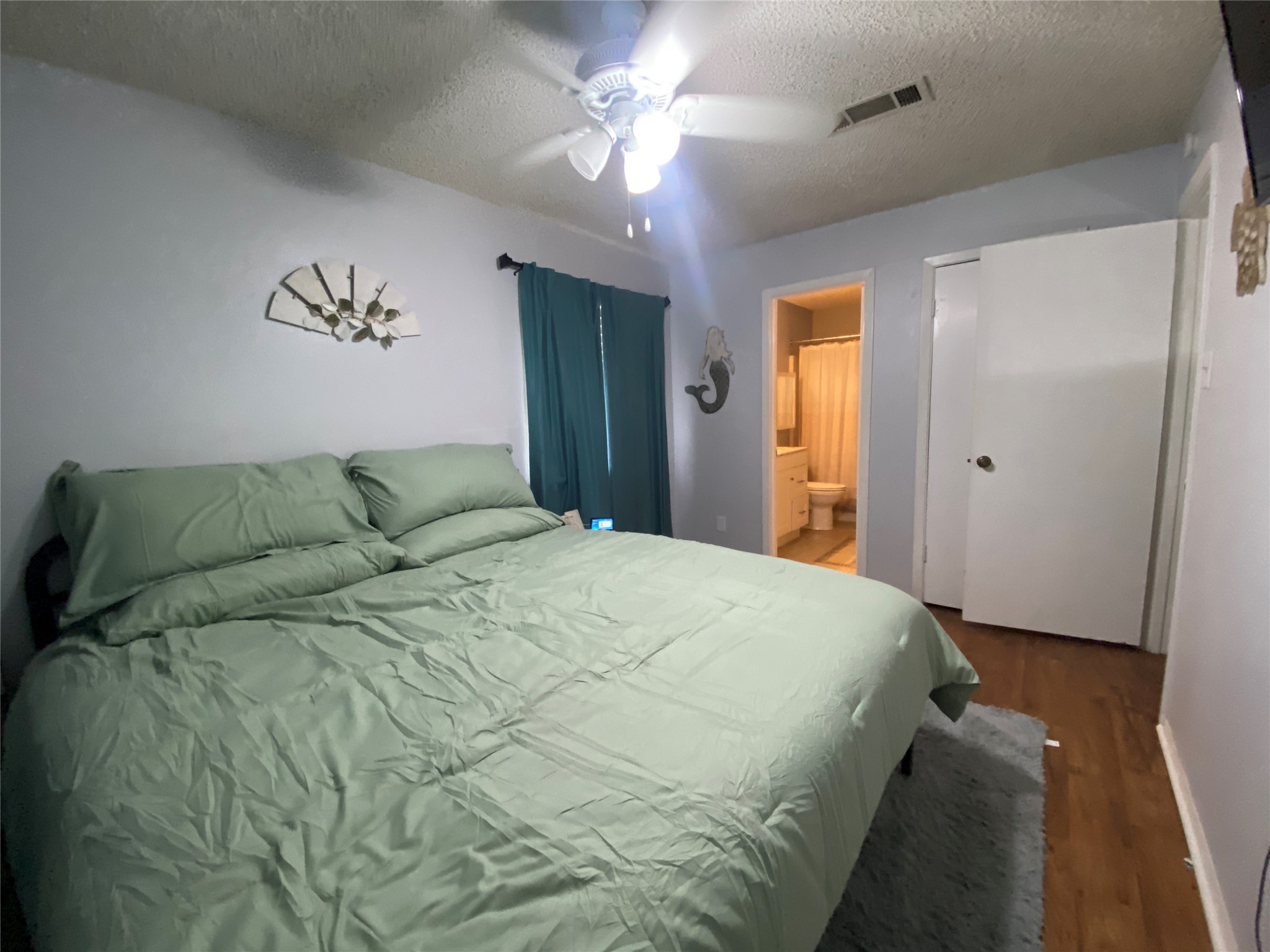 28604 Magnolia Court Point Blank, TX 77364 - Photo 7 of 30 a spacious bedroom with a bed and a chandelier