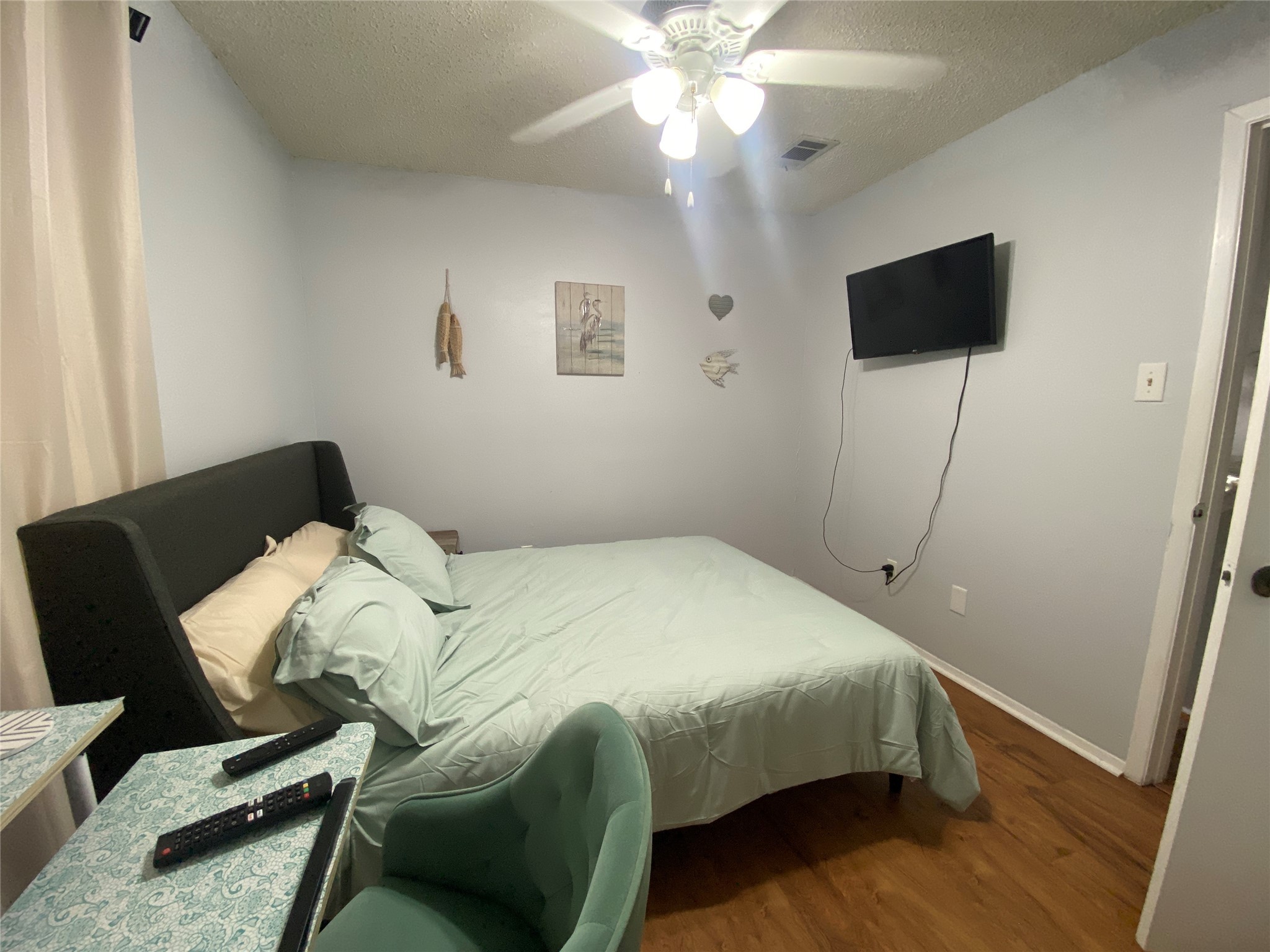 28604 Magnolia Court Point Blank, TX 77364 - Photo 9 of 30 a bedroom with a bed and a flat tv screen on the dresser