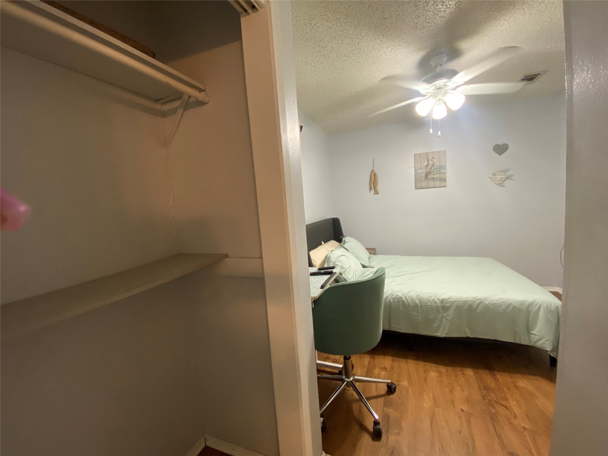 28604 Magnolia Court Point Blank, TX 77364 - Photo 10 of 30 a bedroom with a bed and a chandelier fan