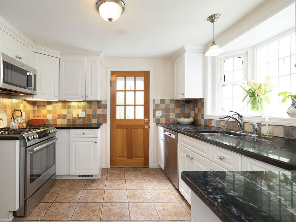 33 Bay View Road Wellesley, MA 02482 - Photo 12 of 32 a kitchen with stainless steel appliances granite countertop a stove a sink and a microwave