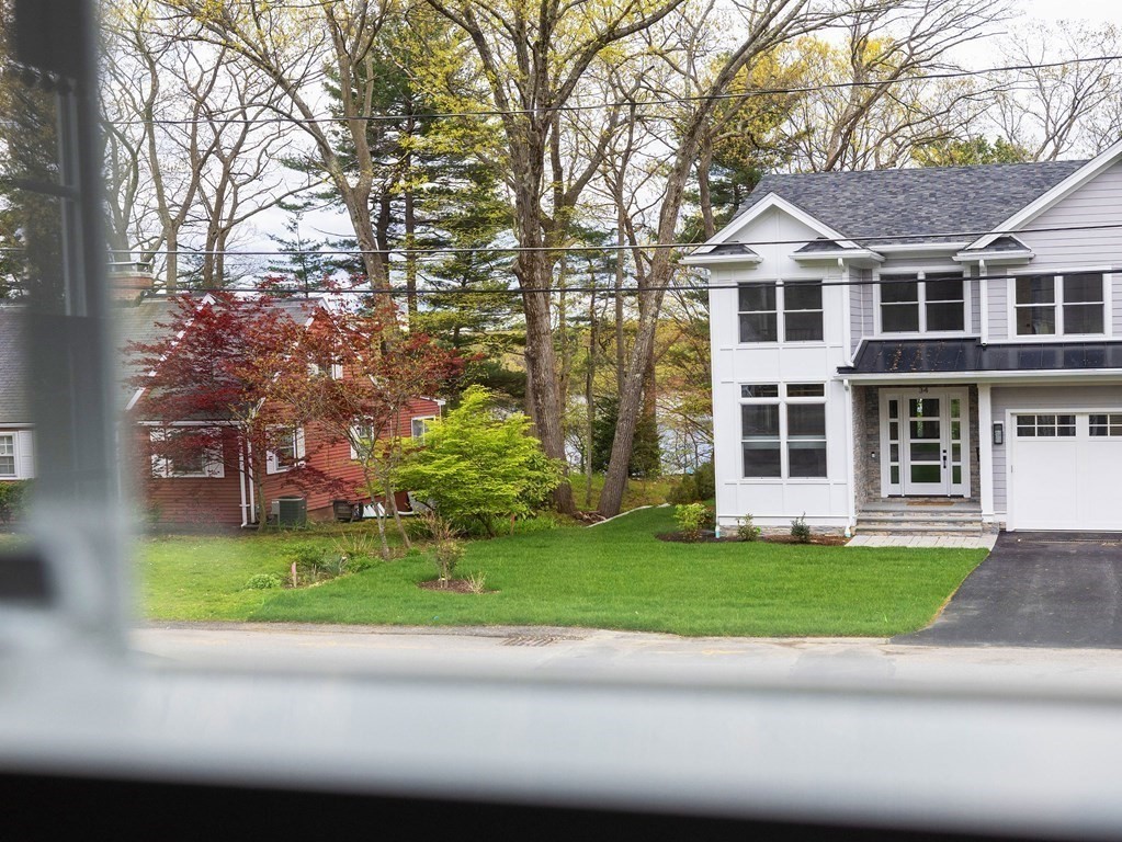 33 Bay View Road Wellesley, MA 02482 - Photo 8 of 32 a front view of a house with a garden and trees