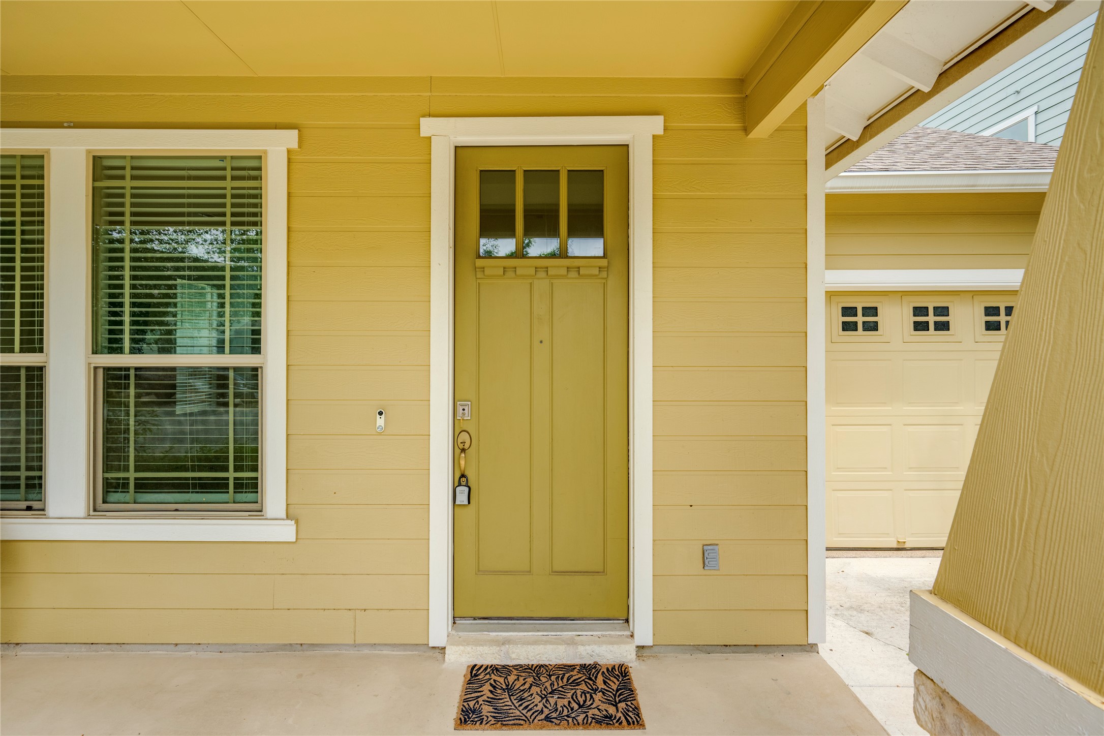 6008 Whipple Way Austin, TX 78745 - Photo 4 of 39 A welcoming entry featuring a lime green door and crisp white trim, promising charm beyond the threshold.