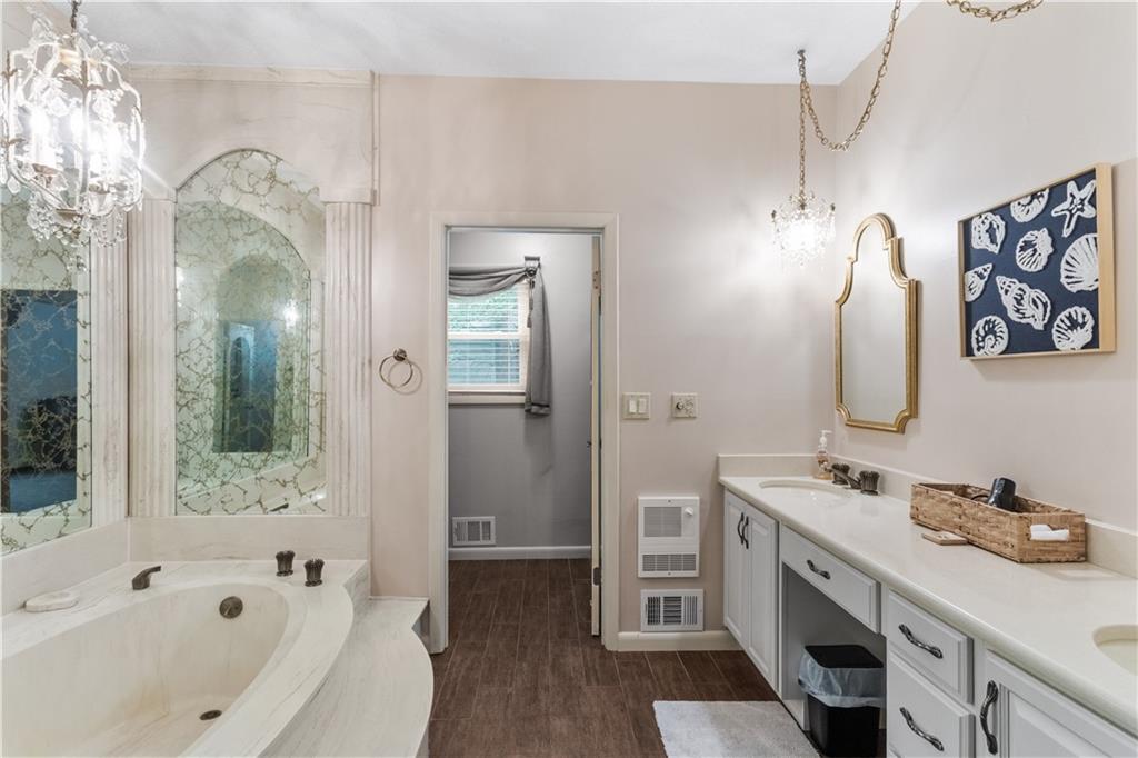 3711 Frey Lake Road Northwest Kennesaw, GA 30144 - Photo 19 of 37 a bathroom with a tub sink and mirror