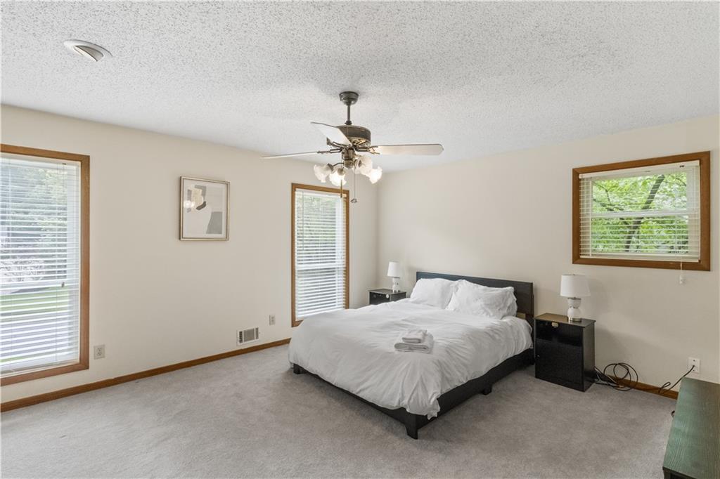 3711 Frey Lake Road Northwest Kennesaw, GA 30144 - Photo 23 of 37 a bedroom with a bed and a chandelier
