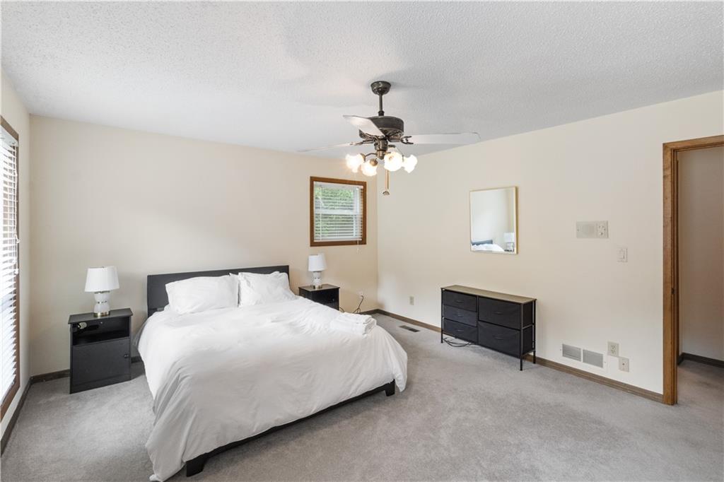 3711 Frey Lake Road Northwest Kennesaw, GA 30144 - Photo 24 of 37 a bedroom with bed and a chandelier