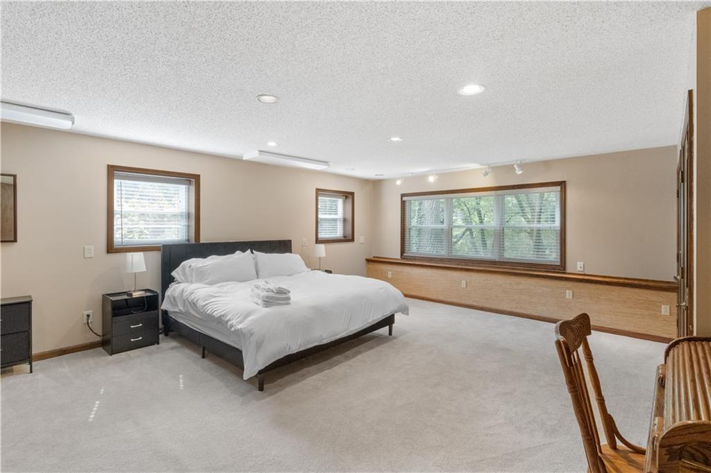 3711 Frey Lake Road Northwest Kennesaw, GA 30144 - Photo 28 of 37 a spacious bedroom with a large bed and a window