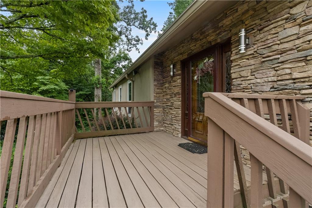 3711 Frey Lake Road Northwest Kennesaw, GA 30144 - Photo 3 of 37 a balcony with wooden floor and fence next to a yard
