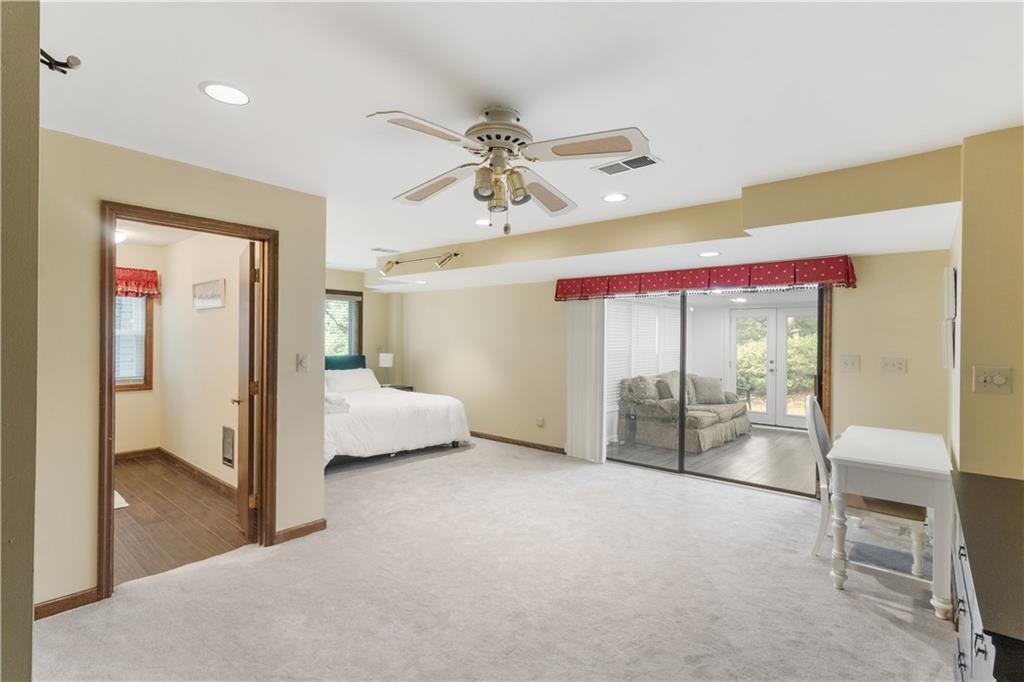 3711 Frey Lake Road Northwest Kennesaw, GA 30144 - Photo 32 of 37 a bedroom with a bed and glass door