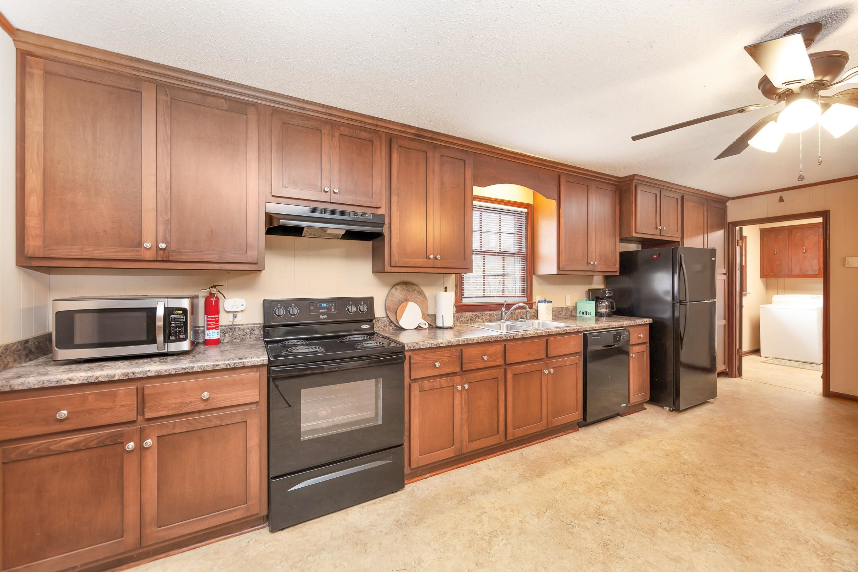835 Smith Road Luray, TN 38352 - Photo 7 of 19 a kitchen with granite countertop stainless steel appliances and cabinets